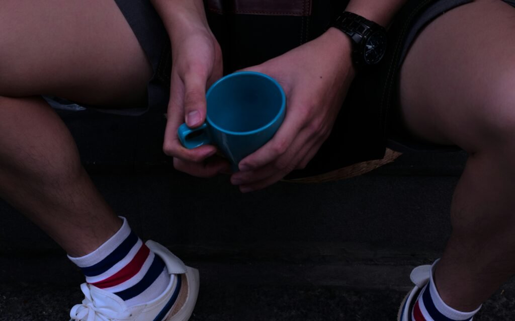 person holding blue ceramic mug
